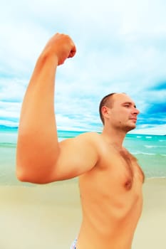 Funny man is showing muscular. Wide-angle lense photo