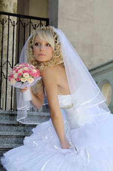 Beautiful young woman in white wedding dress