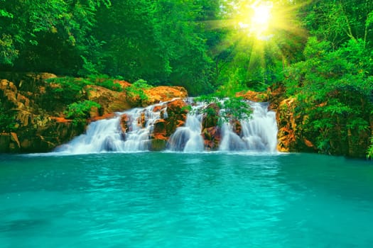 Waterfall in tropical forest at sunny day
