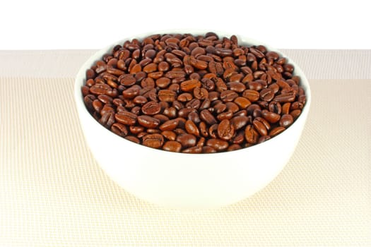 Roasted coffee beans in a white bowl