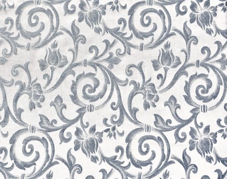 Abstract background of a heavy grey brocade fabric with interwoven repeat design.