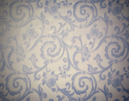 Abstract background of a heavy grey blue brocade fabric with interwoven repeat design.