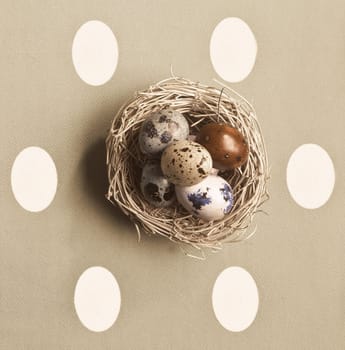 Small nest containing colored eggs over a Easter concept background