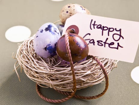 Colored eggs in a small nest with a Happy Easter tag