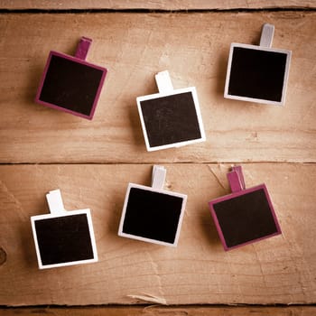 Six Squary Polaroid-style photo frames on a wooden background