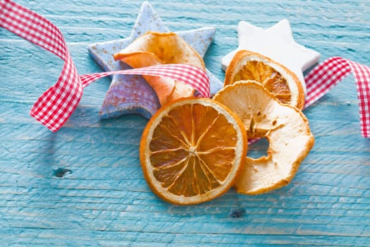 Stars and dried fruits and a checked bow on blue background