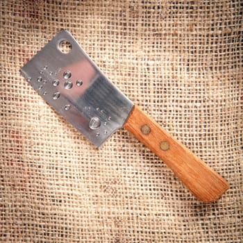 chopping-knife on a fabric coffee bag background