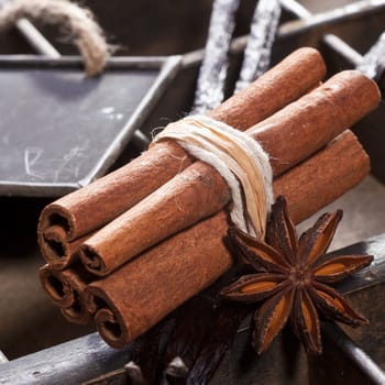 Cinnamon sticks and a memo chalkboard on a type box