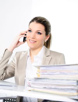 Closeup of businesswoman in the office talking on the phone