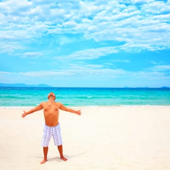 Young man enjoy sun near the ocean