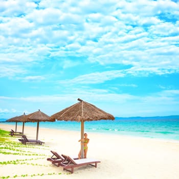 Young woman relaxing on the tropical beach