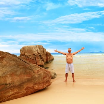 Young man enjoy sun near the ocean