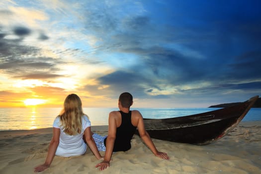Romantic couple at uninhabited island at sunset time