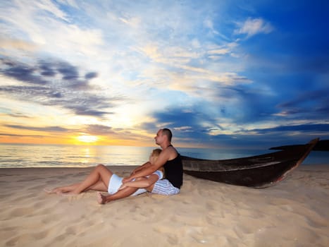 Romantic couple at uninhabited island at sunset time
