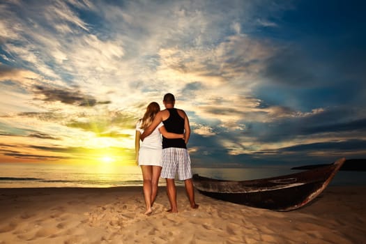 Romantic couple at uninhabited island at  sunrise time