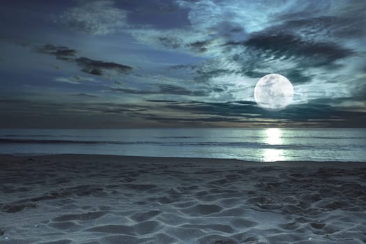 Beautiful beach at twilight time with moon in the sky