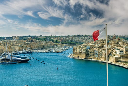 panoramic view on Valletta with the flag of Malta in the foreground