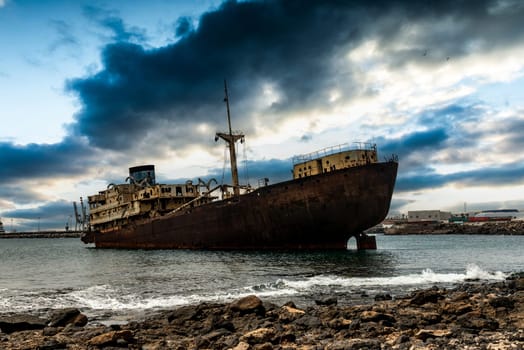 Old rusty industrial Spanish ship, floating ashore as a tourist attraction, Lanzarote