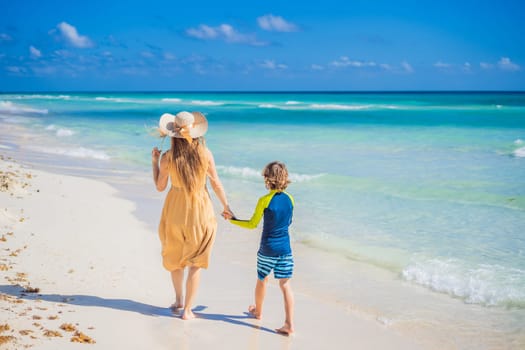 Family having fun and enjoying the white sandy beach on sunny day. Summer vacation for family in tropical paradise caribbean island coast, touristic destination for family vacations and leisure. GO Everywhere.