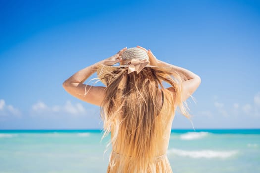 Happy traveller woman in yellow dress enjoys her tropical beach vacation. GO Everywhere.