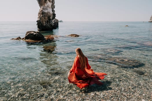 Woman travel sea. Happy tourist taking picture outdoors for memories. Woman traveler looks at the edge of the cliff on the sea bay of mountains, sharing travel adventure journey.