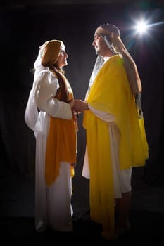 A couple in love or a married couple in stylized Eastern clothing from Israel, Palestine, Iran, Pakistan together. Tender photo session in the style of the Middle East and the Bible