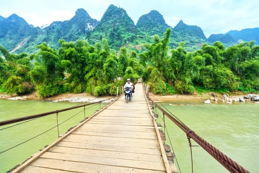 Wooden bridge over mountain river. Northern Vietnam
