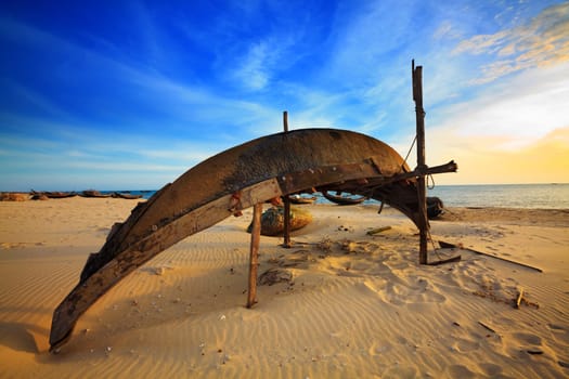 Old fisherman boat at sunrise time. Hue province. Vietnam
