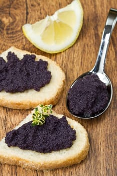 caviar canape on wood background