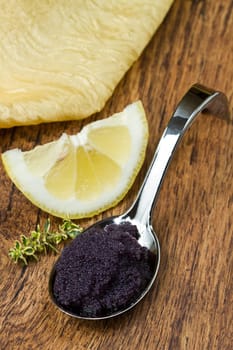 black caviar on wooden background