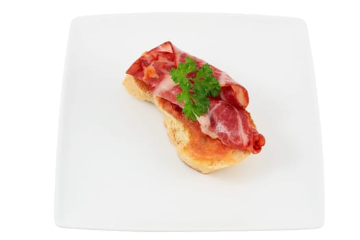 cover of bread with lomo tomato parsley and olive oil cut off and isolated