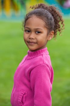 Outdoor portrait  of a cute little African Asian girl