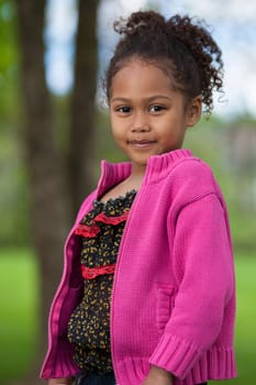 Outdoor portrait  of a cute little African Asian girl
