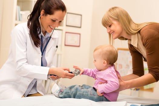 Cute baby being examine by pediatrician with stethoscope