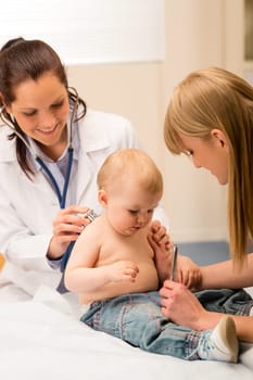 Female pediatrician checking cute baby girl with stethoscope