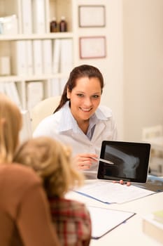 Female pediatrician showing bone X-ray on tablet medical office