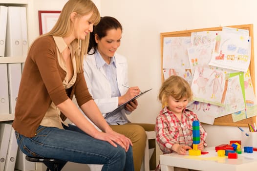 Visit at pediatrician observe child girl play at medical office