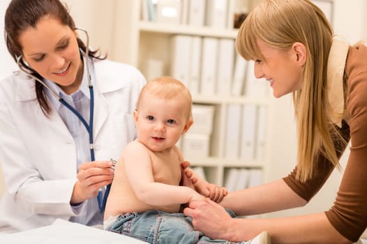 Female pediatrician checking cute baby girl with stethoscope