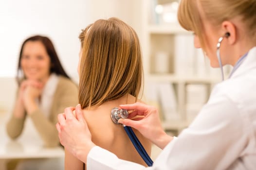 Girl being examine with stethoscope by pediatrician