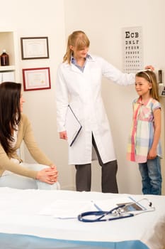 Medical examination at pediatrist girl measure height and weight