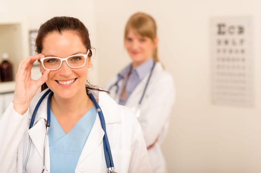 Female doctor ophthalmologist with funny white glasses looking at camera