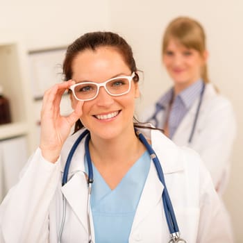 Female doctor with funny white glasses looking at camera