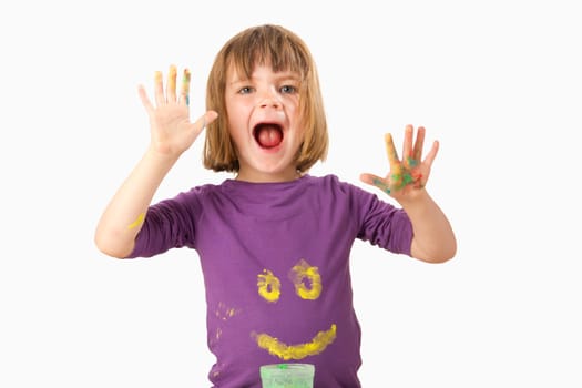 Girl paints a face on her sweater with finger paints