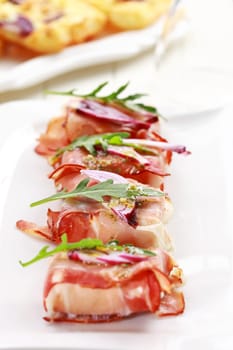 Prosciutto cheese rolls with arugula