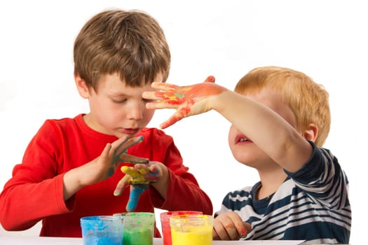 Children paint with finger paints and have fun doing it