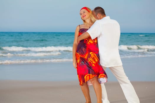 Young loving couple have a fun on the beach