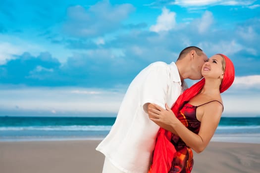 Young loving couple have a fun time near the ocean