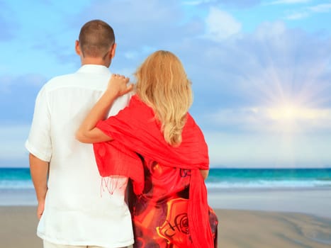 Young loving couple looking to the ocean