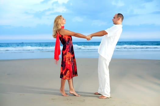 Young loving couple have a fun on the beach