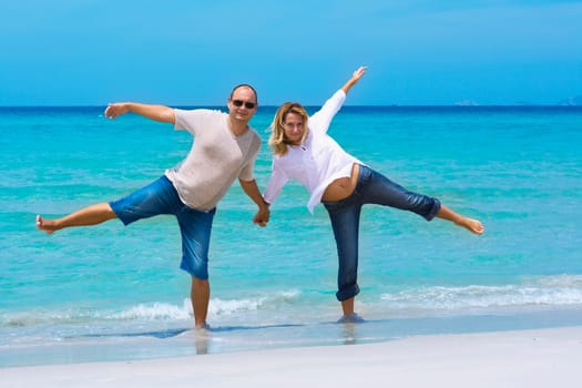Young couple have a fun on the tropical beach